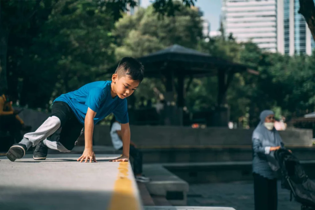 Energetic Kid Spinning on Outdoor Obstacle