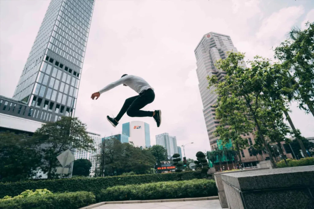 Thrilling Parkour Jump: Man Soaring through the Air with Precision and Agility